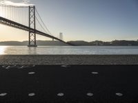 a bicycle lane on a paved beach below the golden gate bridge in san francisco, california