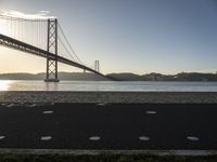 a bicycle lane on a paved beach below the golden gate bridge in san francisco, california