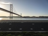 a bicycle lane on a paved beach below the golden gate bridge in san francisco, california