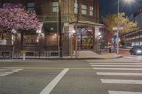 a stoplight in front of a red brick building and traffic lights on a city street