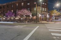 a stoplight in front of a red brick building and traffic lights on a city street