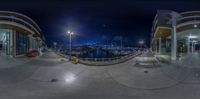 a red car parked in front of a pier at night in an upside down fisheye