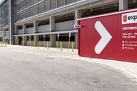 a sign for exit point of entrance in an industrial building parking area where to pick up the door