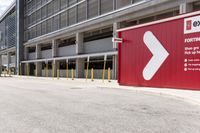 a sign for exit point of entrance in an industrial building parking area where to pick up the door