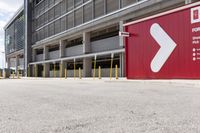 a sign for exit point of entrance in an industrial building parking area where to pick up the door