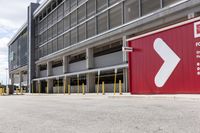 a sign for exit point of entrance in an industrial building parking area where to pick up the door