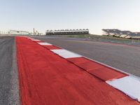 Red Race Car Speeding on Race Track