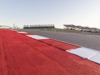 Red Race Car Speeding on Race Track