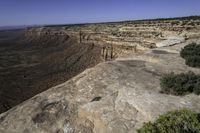 an arid plain covered with rocks and water, with small vegetation on the side of it