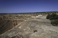 an arid plain covered with rocks and water, with small vegetation on the side of it