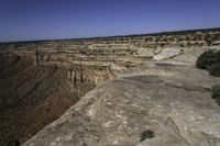 an arid plain covered with rocks and water, with small vegetation on the side of it