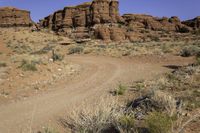 the red rocks are everywhere in the desert, and is full of sparse dirt plants