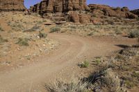 the red rocks are everywhere in the desert, and is full of sparse dirt plants