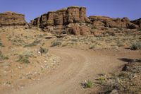 the red rocks are everywhere in the desert, and is full of sparse dirt plants