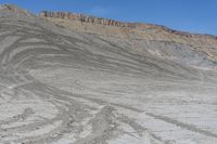 a red truck is driving through the rocky landscape of the desert of an arid area