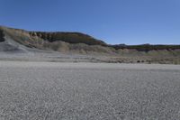 a skateboard with black markings on it in the middle of a desert area,