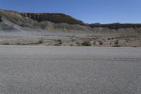 a skateboard with black markings on it in the middle of a desert area,