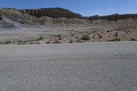 a skateboard with black markings on it in the middle of a desert area,