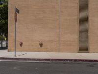 a red stop sign sitting in front of a wall with two brown fire hydrants