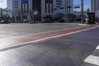 a red stripe on the sidewalk near cars on the street of the big city in daytime