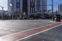 a red stripe on the sidewalk near cars on the street of the big city in daytime