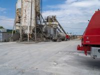 the red truck has been parked at the factory and waiting for customers to arrive into it