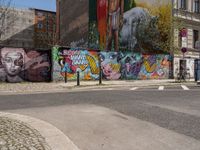 an empty street with a group of people on it and graffiti covered buildings in the background