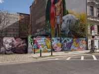 an empty street with a group of people on it and graffiti covered buildings in the background