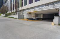 an empty, empty parking lot next to a building with large windows on top of it