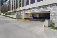 an empty, empty parking lot next to a building with large windows on top of it