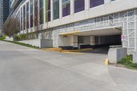 an empty, empty parking lot next to a building with large windows on top of it