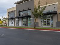 a road is empty at a retail store in this neighborhood's urban area of an outside business