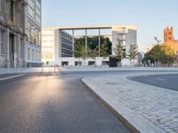 a paved road with cars driving down it that looks like a roundabout of gravels