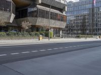 a city street with multiple buildings and two bikes on the road, one empty, one parked