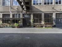 the entrance to a business with a walkway between two buildings and a bench on both side