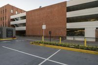 the parking space in front of this brick building has multiple parking spaces along side of it