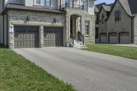 two garages and a driveway at an upscale house in the suburbs of toronto, ontario