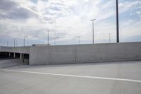 the sky above the concrete walls and road on the road is gray with white lines