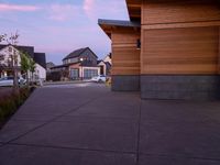 the sun has just set on the roof and a pink hued sky is reflected in the window