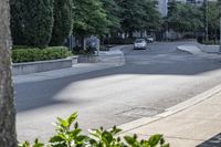 a car driving down an empty street lined with tall buildings and trees in the background