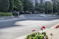 a car driving down an empty street lined with tall buildings and trees in the background