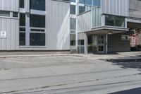 an exterior view of the building on a city street with a parking meter visible in front of it