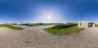 this is a 360 - view of a road and houses in the background from a fish eye lens