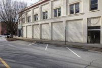 a picture of an empty store front with boarded doors on the street corner at the corner