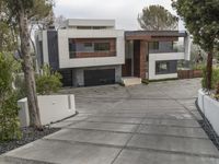 the exterior and landscape of a modern house in los angeles, california with stone and wood