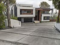 the exterior and landscape of a modern house in los angeles, california with stone and wood