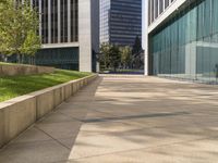 a building and grass outside with the sunlight shining on the ground next to the buildings