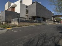 modern building with concrete, concrete, and glass exterior on a street corner in a suburban city setting