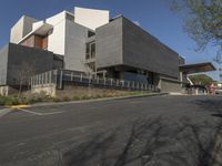 modern building with concrete, concrete, and glass exterior on a street corner in a suburban city setting