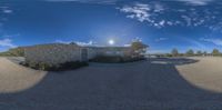 this is an 360 - angle picture of a curved driveway between a brick and stone wall